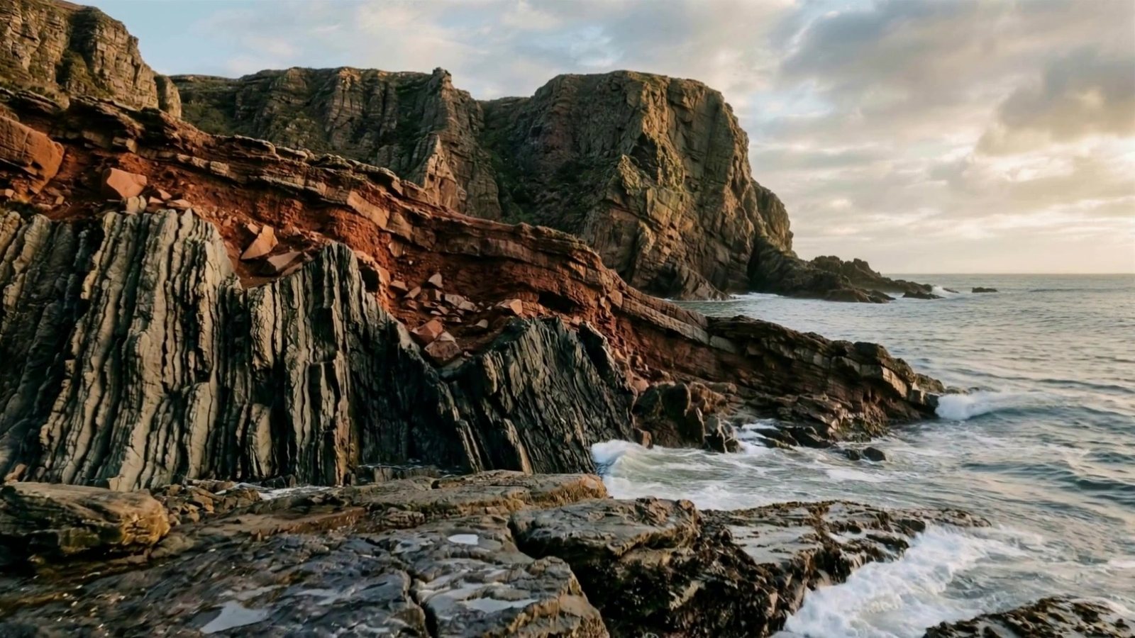 Siccar Point, Scotland: red sandstone lying across upturned grey beds